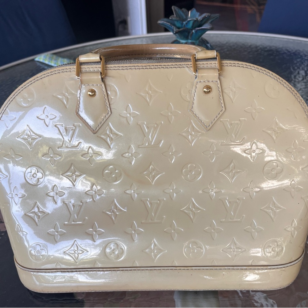 Louis Vuitton ( authentic) well loved creme and gold Alma bag.